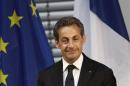 Former French President Sarkozy pauses during speech in Berlin