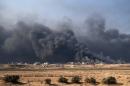Smoke rises from burning oil wells in Qayyarah, on the outskirts of Mosul, on November 4, 2016