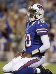 File - In this Aug. 25, 2012 file photo, Buffalo Bills' Vince Young kneels on the turf after throwing an interception against the Pittsburgh Steelers during the second half of a preseason NFL football game in Orchard Park, N.Y. Six years after entering the NFL as the third player taken in the draft, Young finds himself without a team and with only a fraction of the money he received from a contract that paid him a guaranteed $26 million. (AP Photo/Gary Wiepert, File)