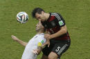 Germany's Mats Hummels heads the ball over United States' Clint Dempsey during the group G World Cup soccer match between the USA and Germany at the Arena Pernambuco in Recife, Brazil, Thursday, June 26, 2014. (AP Photo/Hassan Ammar)