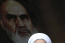 Iranian President Hassan Rouhani delivers his speech under a portrait of the late revolutionary founder Ayatollah Ruhollah Khomeini during a rally to commemorate the anniversary of the 1979 Islamic revolution, at the Azadi (Freedom) Sq. in Tehran, Iran, Thursday, Feb. 11, 2016. The nationwide rallies commemorate Feb. 11, 1979, when followers of Ayatollah Khomeini ousted U.S.-backed Shah Mohammad Reza Pahlavi. (AP Photo/Vahid Salemi)