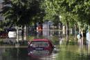 A car is seen stranded in the flooded town of Obrenovac