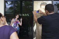 In this March 6, 2012 photo, Milena Rangel, from Macae, Brazil, poses for a photo taken by her husband Vanderson Rangel as they shop at the Sawgrass Mills mall in Fort Lauderdale, Florida. Brazilian travelers spend more per capita than any other visitors to the U.S. (AP Photo/Felipe Dana)