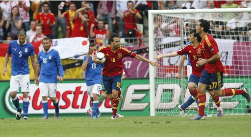 Spain's Cesc Fabregas, center, celebrates with teammate, after scoring a goal during the Euro 2012 soccer championship Group C match between Spain and Italy in Gdansk, Poland, Sunday, June 10, 2012. (AP Photo/Michael Sohn)