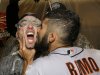 Sergio Romo kisses Marco Scutaro as they are sprayed with champagne in the locker room as San Francisco Giants celebrate after the Giants defeated the Detroit Tigers, 4-3, in Game 4 of baseball's World Series  Sunday, Oct. 28, 2012, in Detroit. The Giants won the World  Series 4-0. (AP Photo/David J. Phillip)