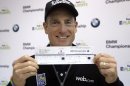 Jim Furyk holds up his scorecard after a news conference in the second round of the BMW Championship golf tournament at Conway Farms Golf Club in Lake Forest, Ill., Friday, Sept. 13, 2013. Furyk posted a single round 59, tying a PGA Tour record. (AP Photo/Charles Rex Arbogast)