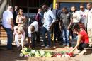People lay flowers and pay their respects where constitutional law professor Gilles Cistac was murdered on March 3, 2015, in Maputo, Mozambique