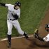 New York Yankees' Ichiro Suzuki, left, of Japan, runs past Baltimore Orioles catcher Matt Wieters to score a run on a double by Robinson Cano in the first inning of Game 2 of the American League division baseball series on Monday, Oct. 8, 2012, in Baltimore. (AP Photo/Patrick Semansky)