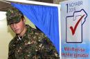 An Azeri soldier leaves a voting booth at a polling station in Baku on November 1, 2015 during Azerbaijan's parliamentary election