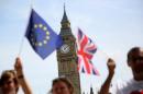 Participants hold a British Union flag and an EU flag during a pro-EU referendum event at Parliament Square in London