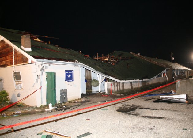 This image provided by Churchill Downs shows the barn housing horses trained by Steve Margolis which was among the most heavily-damaged by a possible tornado that struck Wednesday night June 22, 2011.