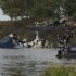 FILE - In this Wednesday, Sept. 7, 2011 file photo, rescuers work at the crash site of Russian Yak-42 jet near the city of Yaroslavl, on the Volga River about 150 miles (240 kilometers) northeast of Moscow, Russia. The crash killed 44, including an entire top ice hockey team, and increased public fears about safety of Russia's aviation. (AP Photo/Misha Japaridze)
