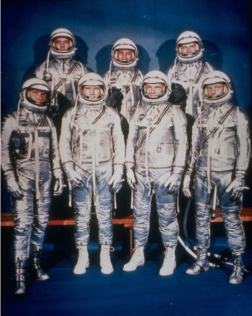 FILE - This 1961 file photo provided by NASA shows the original seven Mercury astronauts in their silver spacesuits. From left, first row are Walter Schirra Jr., Donald Slayton, John Glenn and Scott C