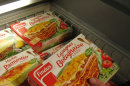 A customer holds a pack of Findus Beef Lasagne Bolognaise in a freezer of a supermarket in Nice, southeastern France, Monday, Feb. 11, 2013. Complex trading between wholesalers has made it increasingly difficult to trace the origins or destination of food like the horsemeat disguised as beef being sold in frozen meals across Europe's open borders, and France's agricultural minister said it was up to regulators to find a way 