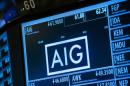 FILE PHOTO - Current information related to insurance company AIG is displayed above the floor of the New York Stock Exchange