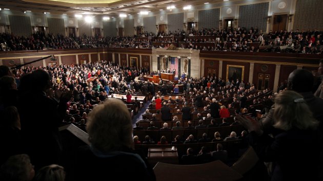 Members of the gallery stand and applaud as U.S. President Barack Obama delivers his State of the Union address to the joint session of Congress on Capitol Hill in Washington