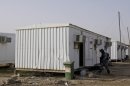 An Iraqi soldier inspects prefabricated houses in February 2012 at the former US military base Camp Liberty