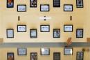 An employee rests a hand on a table displaying iPads as part of the display is reflected on a glass surface at the Passeig de Gracia Apple store in Barcelona