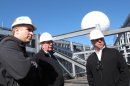Mitch Olorenshaw, left, whose company built the giant ball atop the Revel casino in Atlantic City N.J.; Cliff Wildgoose, director of engineering and construction for Revel, center; and Mitch Gorshin, right, who designed the ball, discuss it during testing of the device on the casino's rooftop on March 7, 2012. (AP Photo/Wayne Parry)