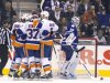 The New York Islanders celebrate next to Toronto Maple Leafs' goalie Ben Scrivens after Islanders Brad Boyes scored in the second period of their NHL hockey game in Toronto