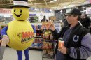 A customer smiles after receiving a free Mega Millions Lottery ticket from the Hoosier Lottery's Mega Millions mascot at a store in Zionsville, Ind., Friday, March 30, 2012. The Mega Millions Lottery jackpot has reached more than $600 million. (AP Photo/Michael Conroy)