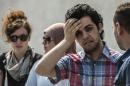 Newly freed Al-Jazeera news channel's journalist Abdullah Elshamy (2nd R) stands outside the court during the trial of three of his colleagues for allegedly supporting the Muslim Brotherhood on June 23, 2014