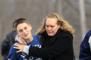 Doug Gasper, a ninth grader at Chardon High School, is hugged by his mother, Sandy, as they leave Maple Elementary School Monday, Feb. 27, 2012, in Chardon, Ohio. Students assembled at Maple Elementary School after a shooting took place at the high school. A gunman opened fire inside the high school's cafeteria at the start of the school day, wounding four students, officials said. A suspect is in custody. (AP Photo/Tony Dejak)