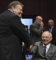<p>               Greek Finance Minister Evangelos Venizelos, left, shakes hands with German Finance Minister Wolfgang Schaeuble during a round table meeting of eurozone finance ministers at the EU Council building in Brussels on Monday, Feb. 20, 2012. Eurozone governments will likely approve on Monday a long-elusive rescue package for Greece, saving it from a potentially calamitous bankruptcy next month, senior officials said. But finance ministers meeting in Brussels will have a few last issues to wrangle over, such as tighter controls over Greece's spending and further cuts to the country's debt load. (AP Photo/Yves Logghe)
