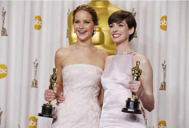 Jennifer Lawrence and Anne Hathaway pose with their Oscars backstage at the 85th Academy Awards in Hollywood, California