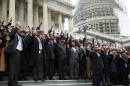 African-American Congressional staffers stage walk out with Hands Up Don't Shoot pose on the steps of the House of Representatives in Washington to protest the deaths of Michael Brown and Eric Garner