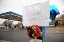 A poster is pinned to a makeshift memorial December 24, 2014, for black teen Antonio Martin in Berkeley, Missouri