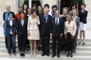 FILE - In this May, 17, 2012 file photo, French President Francois Hollande, second right, and Prime Minister Jean-Luc Ayrault, center, pose with women of the cabinet after the first weekly cabinet meeting, at the Elysee Palace in Paris. Prime Minister Jean-Marc Ayrault has asked the French equality ministry to set up a series of 45 minute workshops, where politicians are given examples of sexism in daily life and with the aid of slide-shows taught how to avoid sexist stereotypes in political communication. First row from the left: Housing Minister Cecile Duflot, Women's Rights minister Najat Vallaud-Belkacem, Social Affairs Minister Marisol Touraine, Justice Minister Christiane Taubira, right. second row from the left: Deputy Justice Minister delphine Batho, Deputy Education Minister George Pau-Langevin, Sports Minister Valerie Fourneyron, Culture Minister Aurelie Filippeti, Family Affairs Dominique Bertinotti, State Labor Minister Marylise Lebranchu, Environment Minister Nicole Bricq. Top from the left: Minister for Small Business and the Digital Economy Fleur Pellerin, Deputy minister in charge of French citizen living abroad and French speaking countries Yamina Benguigui , second right, and Elderly People Minister Michele Delaunay. (AP Photo/Michel Euler, File)