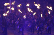 Performers carrying torches enter the Olympic Stadium during the closing ceremony for the 2012 Paralympics games, Sunday, Sept. 9, 2012, in London. (AP Photo/Kirsty Wigglesworth)