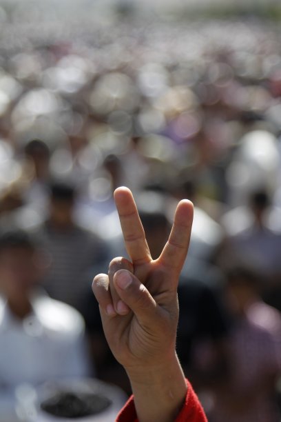 A boy gestures with the victory sign during a rally to demand the trial of Yemen's outgoing President Saleh in Sanaa