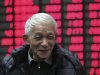 An investor smiles at a private securities company Monday Jan. 9, 2012 in Shanghai, China. Mainland Chinese shares saw their biggest gains in almost three months after Premiere Wen Jiabao's speech over inspiring the stock market confidence, analysts said. The benchmark Shanghai Composite Index gained 2.89 percent, or 62.5 points, to 2225.89. (AP Photo)