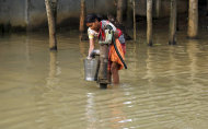 A village woman pumps drinking water amid floodwaters at Jhikiral village, in Howrah district, in the eastern Indian state of West Bengal, Saturday, Aug. 20, 2011. Flood situation in West Bengal continued to be grim as the death toll shot to 36 Thursday, according to a news agency. India receives much of its rainfall during the monsoon season which lasts from July to September. (AP Photo)