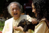 FILE - In this Feb. 25, 2002 file photo, Sitar maestro Pandit Ravi Shankar, left, and his daughter Anoushka Shankar laugh during the shooting of a film endorsing the strengthening of Indian laws against animal cruelty in New Delhi. Shankar, the sitar virtuoso who became a hippie musical icon of the 1960s after hobnobbing with the Beatles and who introduced traditional Indian ragas to Western audiences over an eight-decade career, died Tuesday, Dec. 11, 2012. He was 92. (AP photo/Gurinder Osan, File)