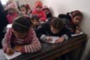 Syrian children attend a class at a school in the Kadi Askar area in the Syria's northern city of Aleppo on February 9, 2013