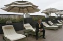 Former Maldives President Mohamed Nasheed poses for a picture at the poolside of a hotel in New Delhi