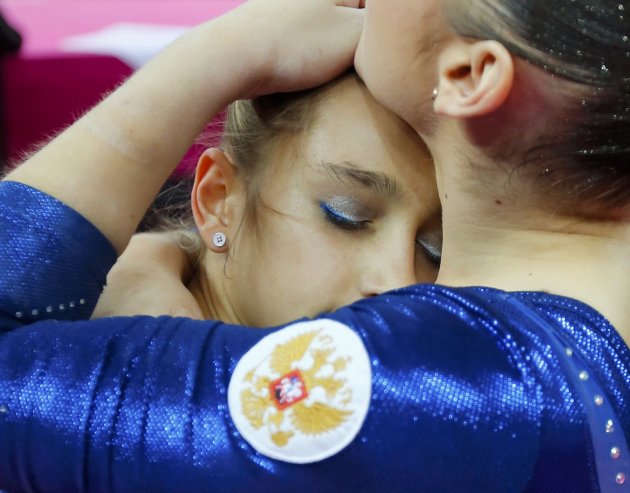 Russia's Victoria Komova and Aliya Mustafina check the scoreboard after the women's individual all-around gymnastics final in the North Greenwich Arena at the London 2012 Olympic Games