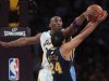 Kobe Bryant of the Los Angeles Lakers blocks a shot by Andre Miller of the Denver Nuggets