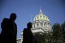 In this Oct. 7, 2015 photo, people walk past the Pennsylvania Capitol building in Harrisburg, Pa. Truly diverse legislatures are rarity across the United States; while minorities have made some political gains, they remain severely underrepresented in Congress and nearly every state legislature, according to an analysis of demographic data by The Associated Press. (AP Photo/Matt Rourke)