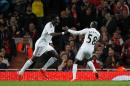 Swansea City's striker Bafetimbi Gomis (L) celebrates scoring his goal with Modou Barrow during the English Premier League football match against Arsenal in London on May 11, 2015