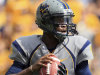 West Virginia quaterback Geno Smith (12) looks for a receiver during the first half of an NCAA college football game against Maryland in Morgantown, W.Va., Saturday, Sept. 22, 2012. (AP Photo/Christopher Jackson)