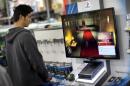 A customer is seen playing a game on Sony Playstation 4, on display at Best Buy store in Pembroke Pines, Florida, on November 15, 2013