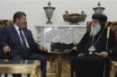 Muslim Brotherhood's President-elect Mohamed Mursi meeting with Egyptian Coptic Bishop Bakhomious at his office in the Presidency, in Cairo