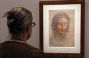 A woman looks at a work by Leonardo Da Vinci named 