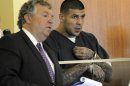 Former New England Patriots football player Aaron Hernandez, right, stands with his attorney Michael Fee, during a bail hearing in Fall River Superior Court Thursday, June 27, 2013, in Fall River, Mass. Hernandez, charged with murdering Odin Lloyd, a 27-year-old semi-pro football player, was denied bail. (AP Photo/Boston Herald, Ted Fitzgerald, Pool)