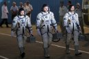 Astronauts Yuri Malenchenko (C) of Russia, Sunita Williams (R) of the US and Akihiko Hoshide (L) of Japan