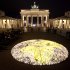 About 5000 candles arrange to a globe lights in front of the Brandenburg Gate prior to the landmark switched off the lights to mark 'Earth Hour'  in  Berlin, Saturday, March 31, 2012. Earth Hour takes place worldwide at 8.30 p.m. local time and is a global call to turn off lights for 60 minutes in a bid to highlight the global climate change. (AP Photo/Markus Schreiber)